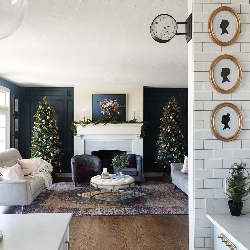 two christmas trees in classic living room