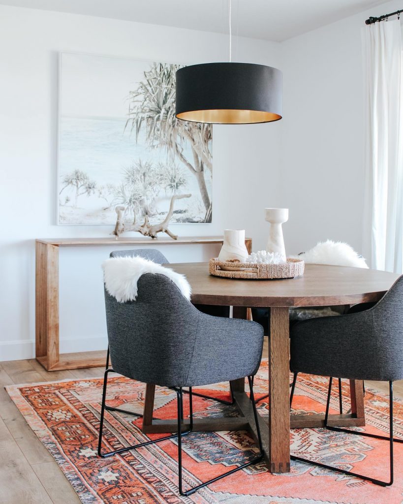 round dining table with traditional rug
