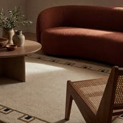 Detailed view of Ivory Yves Bordered Wool Rug by Nate Berkus, pushed up to showcase the color in varied light